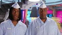 two men in striped shirts standing next to each other