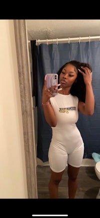 a woman taking a selfie in a bathroom