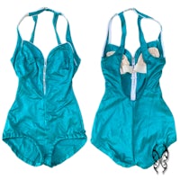 a pair of teal swimsuits with bows on them