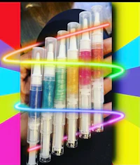 a person is holding a bunch of different colored pens