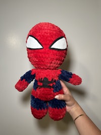 a person holding a crocheted stuffed animal