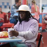 a man sitting at a table in a diner