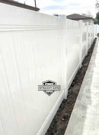 a white vinyl fence in a residential area