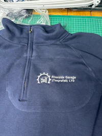 a blue sweatshirt with a logo on it