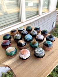 a group of rocks on a wooden table next to a window