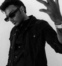 a black and white photo of a man wearing sunglasses