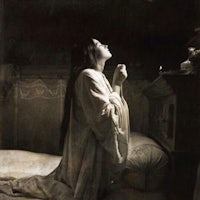 an old photo of a woman praying in bed