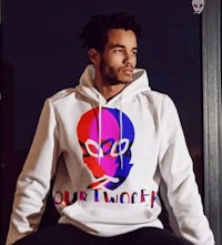 a man wearing a hoodie with a skull on it