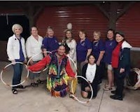 a group of people posing with hula hoops
