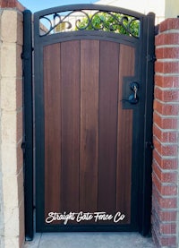 a wooden gate with wrought iron accents