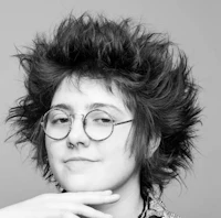 a black and white photo of a woman with glasses