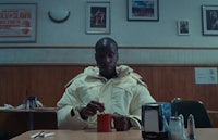 a man sitting at a table in a diner