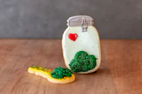 a cookie with a heart in a jar next to a tree