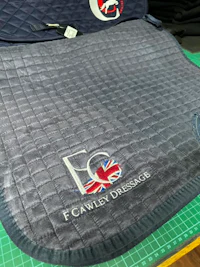a grey saddle pad with the british flag on it