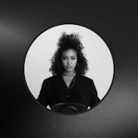 a black and white photo of a woman with curly hair