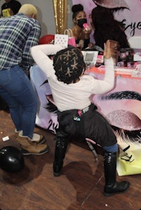 a girl is dancing on a table with balloons