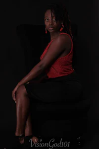a black woman sitting on a black chair
