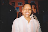 a man smiling in front of a group of people