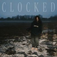 a person standing in a field with the words'clocked'