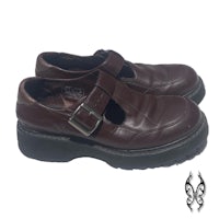 a pair of brown leather shoes with buckles