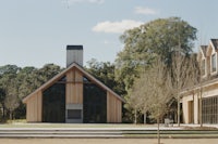 a church with a large wooden building in the middle of a wooded area