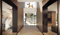 a hallway with a wooden floor and a dog statue