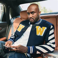 a man sitting in the back seat of a car with a cell phone