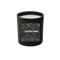 a candle with the word capricorn on it