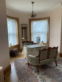 a room with a table and chairs and a rug