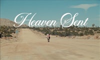 a man walking down a dirt road with the words heaven sent