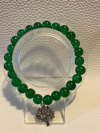 a bracelet with green jade beads and a silver ring