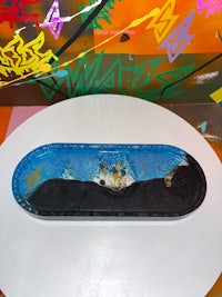 a skateboard on a table with graffiti on it