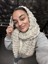 a woman wearing a scarf in an elevator