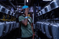 a man talking on a cell phone in a factory