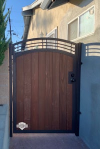 a wooden gate in front of a house