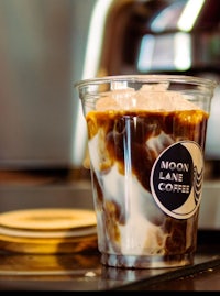 a cup of coffee sitting on top of a machine