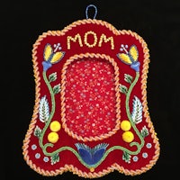 a red embroidered frame with the word mom