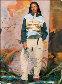 a woman is posing for a photo in a sweatshirt and pants