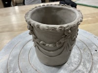 a vase made of clay on a table
