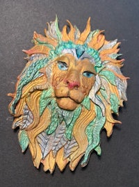 an image of a lion head on a black surface