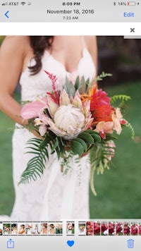 a bride is holding a bouquet of flowers