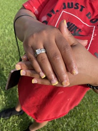 a girl with a ring on her hand holding a ring