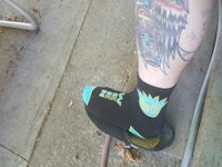 a tattooed leg on a skateboard