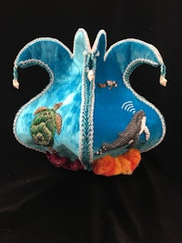 a blue purse with a sea creature on it