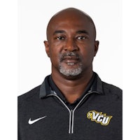 a man wearing a black shirt and a nike jacket