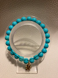 a bracelet with turquoise beads on it