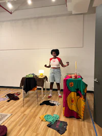 a woman standing in front of a room full of clothes