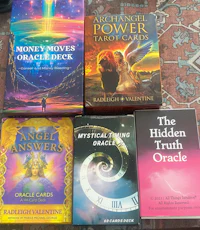 a collection of books about money, power, and oracle cards