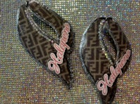 a pair of earrings with the word fendi on them
