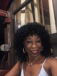 a woman with a curly afro posing for a photo